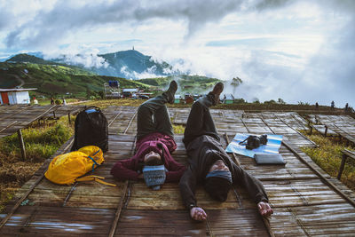 Couple lying on observation point during winter