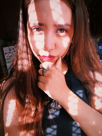 Close-up portrait of thoughtful young woman at home