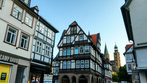 Low angle view of buildings against clear blue sky