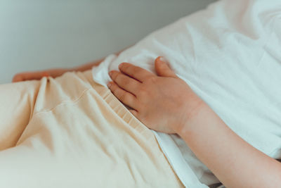 Low section of person lying on bed