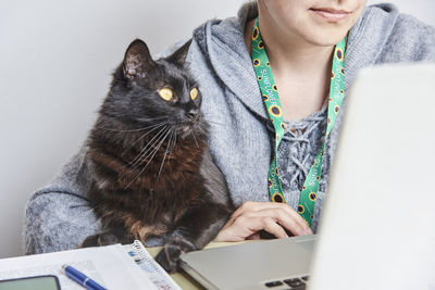 Midsection of woman using laptop