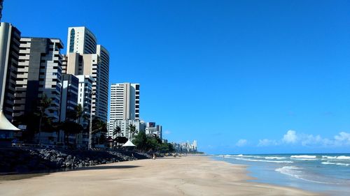 View of beach with city in background