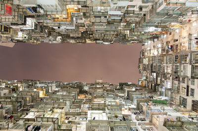 Aerial view of buildings in city against sky