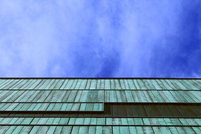 Low angle view of building against cloudy sky