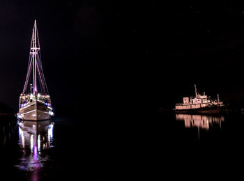 Illuminated ship in water at night