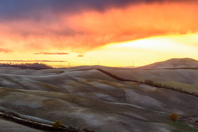 Scenic view of mountains against orange sky