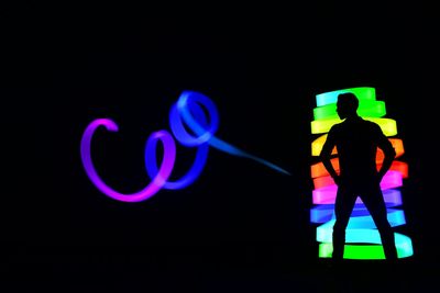 Illuminated light painting against black background