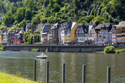 Bridge over river by buildings in city