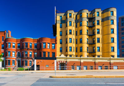 Buildings against clear blue sky