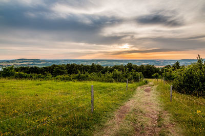 Scenic view of field against sky during sunset