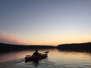 Boat sailing in sea at sunset