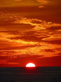 Scenic view of sea against romantic sky at sunset