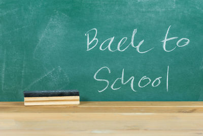 Back to school text on blackboard in classroom