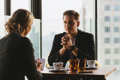 Woman sitting on table at restaurant