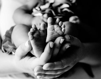 Close-up of woman holding child at home