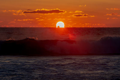 Scenic view of sea against orange sky