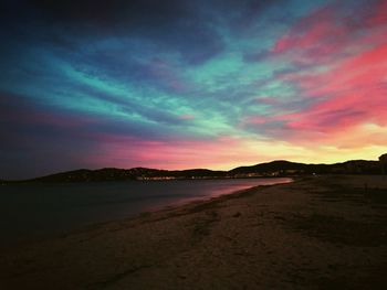 Scenic view of beach against sky during sunset