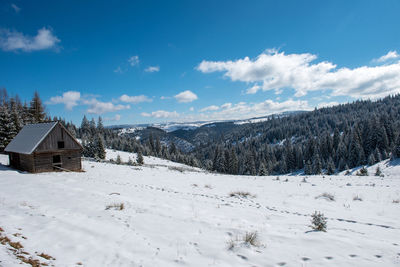 Idyllic winter wonderland mountain scenery with mountain chalet, lodge
