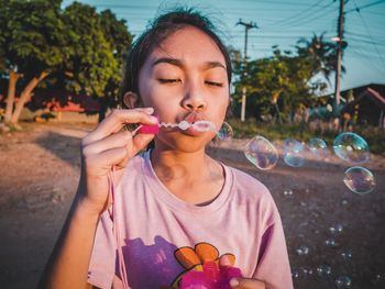 Girl blowing bubbles outdoors