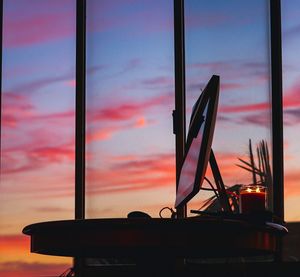 Silhouette built structure against sky at sunset