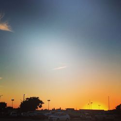 Silhouette city against sky during sunset