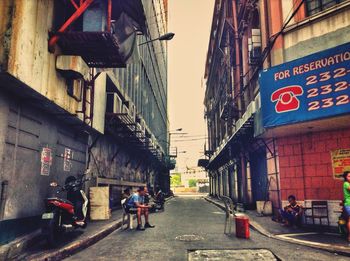 People on street amidst buildings in city