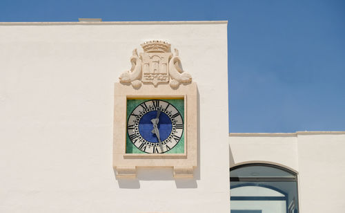 Low angle view of clock tower against sky