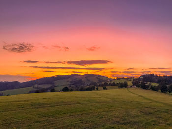 Scenic view of field against sky during sunset