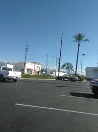 Cars on road against sky in city