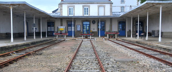 Railroad tracks by buildings in city