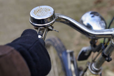 Close-up of human hand holding bicycle handlebar