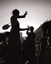 Low angle view of silhouette people against clear sky