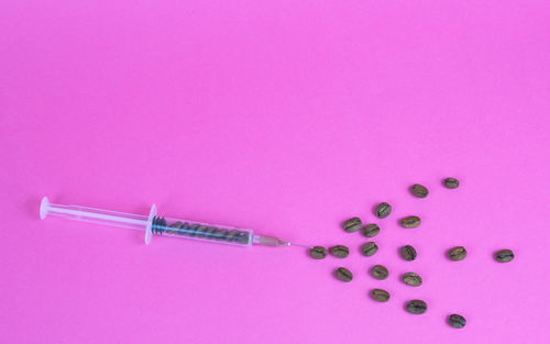 Close-up of pink petals on table against gray background