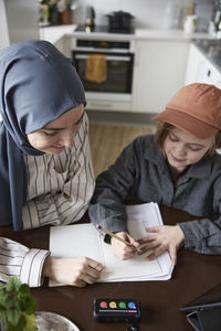Mother helping son with homework at home