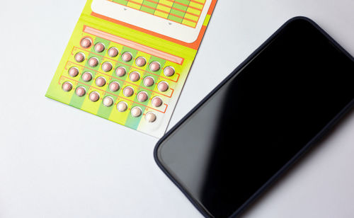 High angle view of mobile phone against white background
