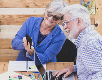 Man and woman using mobile phone