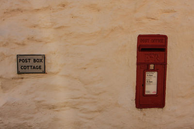 Old post box set into house wall.