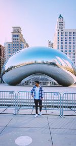 Full length of man standing on building against sky