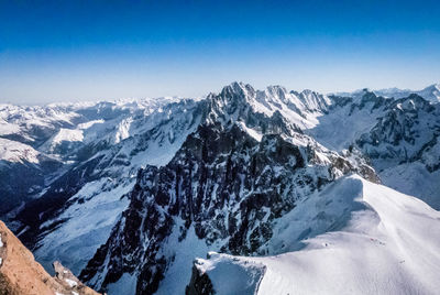 Scenic view of snowcapped mountains against clear sky