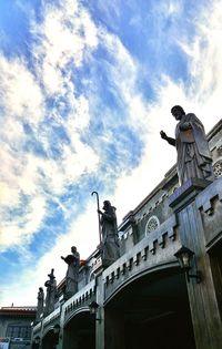 Low angle view of building against cloudy sky