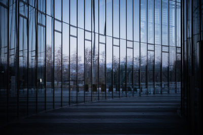 Modern buildings against sky seen through glass window