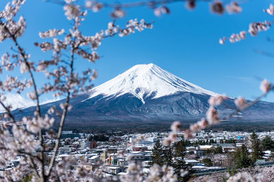 View of cityscape and mt fuji against clear sky