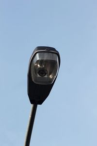 Low angle view of street light against clear blue sky