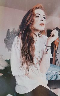 Portrait of young woman looking at home