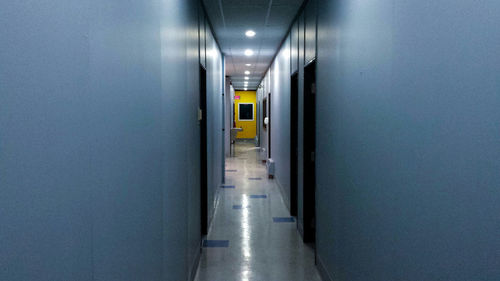 Empty narrow corridor along walls
