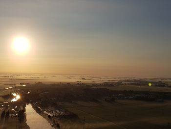 High angle view of illuminated city against sky during sunset