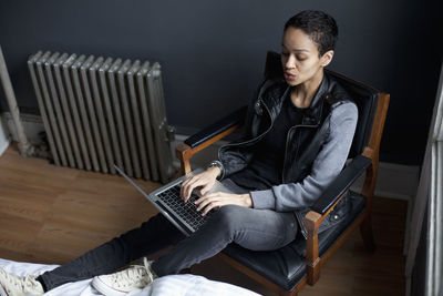 Young woman using laptop while sitting at home