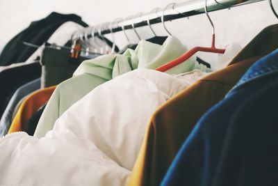 Low angle view of shirts hanging on rod in closet