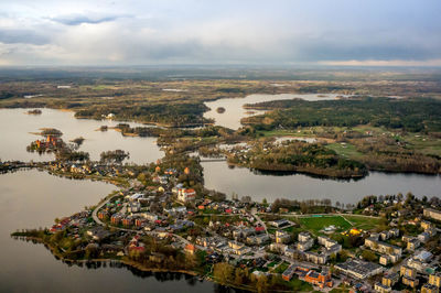 Aerial view of cityscape and river against sky