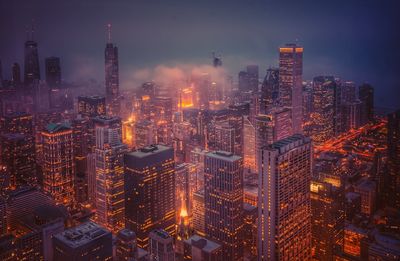 High angle view of illuminated city buildings at night